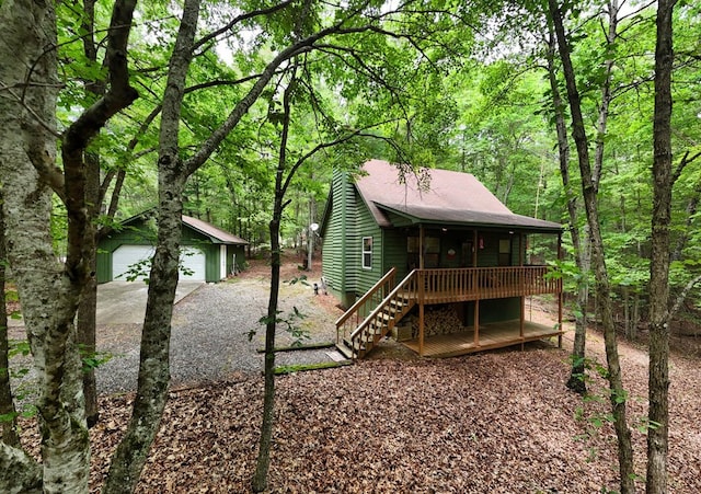 119 Blair Oaks Dr, Blairsville, GA 30512 - back of property with a wooden deck, a garage, an outbuilding, a wooded view, and stairs