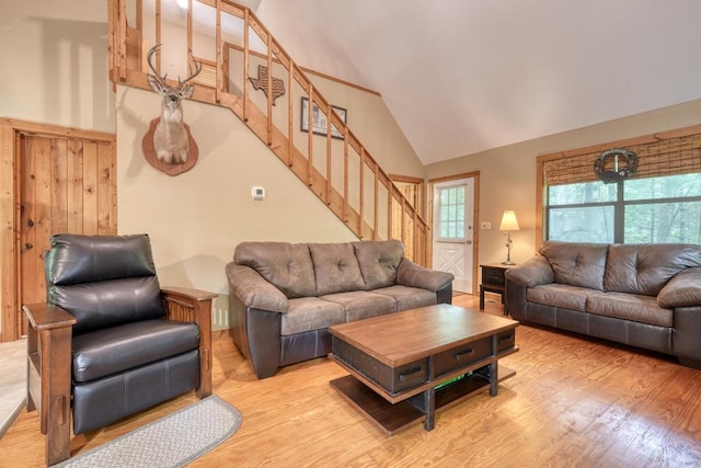 119 Blair Oaks Dr, Blairsville, GA 30512 - living room with high vaulted ceiling, stairs, and light wood-style flooring