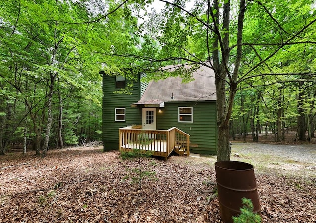 119 Blair Oaks Dr, Blairsville, GA 30512 - back of property featuring a wooden deck, roof with shingles, and a forest view