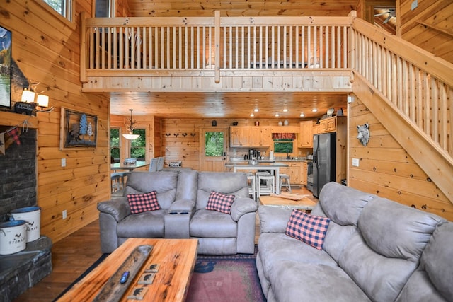 living room with hardwood / wood-style floors and wood walls