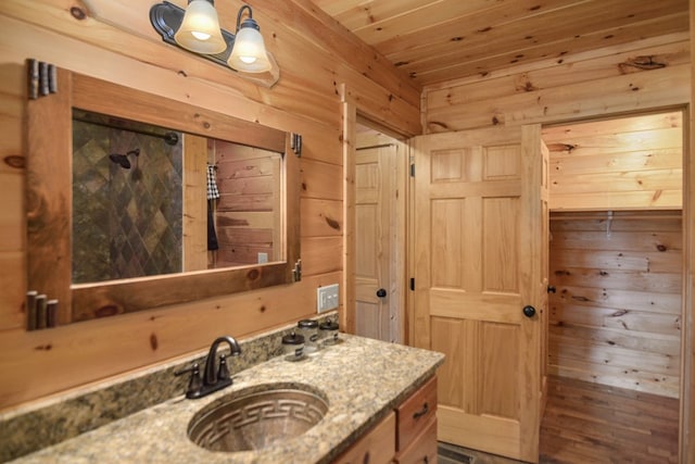 bathroom featuring vanity, wooden ceiling, and wood walls