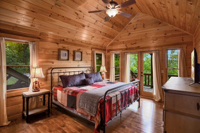 bedroom with wood-type flooring, access to outside, ceiling fan, wooden ceiling, and french doors