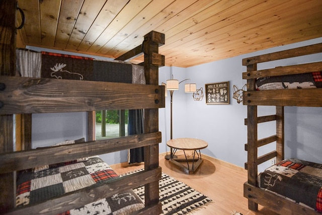 bedroom with wood ceiling and hardwood / wood-style floors