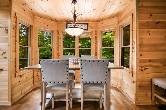 sunroom with a healthy amount of sunlight and wood ceiling