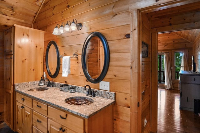 bathroom with wood ceiling, vaulted ceiling, and wooden walls