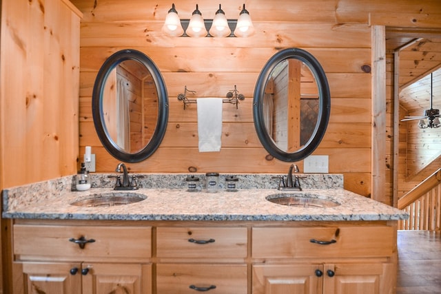 bathroom with vanity and wooden walls