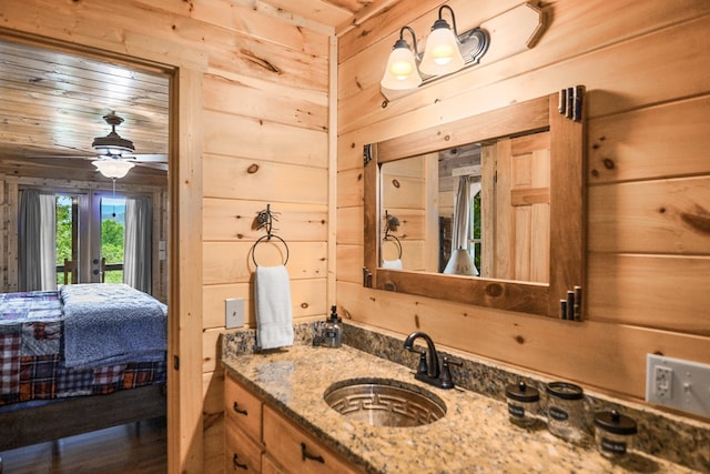 bathroom featuring vanity, wooden ceiling, wooden walls, and french doors