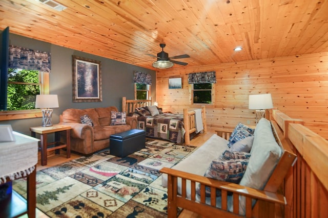 living room with wooden ceiling, a ceiling fan, recessed lighting, wood finished floors, and wooden walls