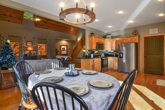 dining room with stairway, light wood finished floors, and recessed lighting