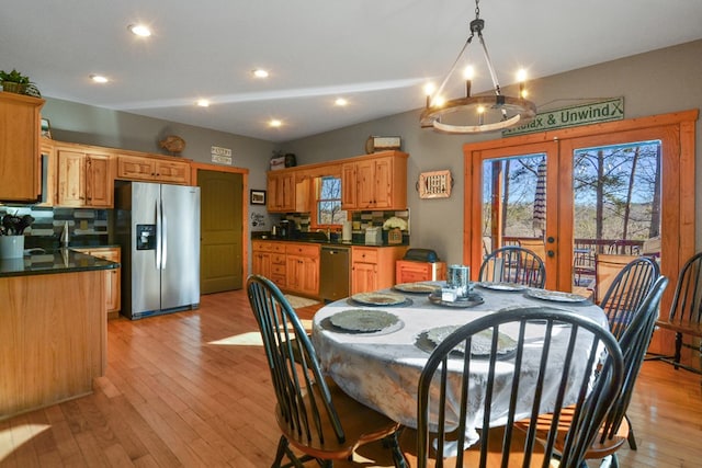dining area featuring plenty of natural light, light wood finished floors, recessed lighting, and french doors