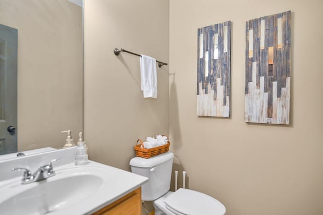 bathroom with toilet and vanity