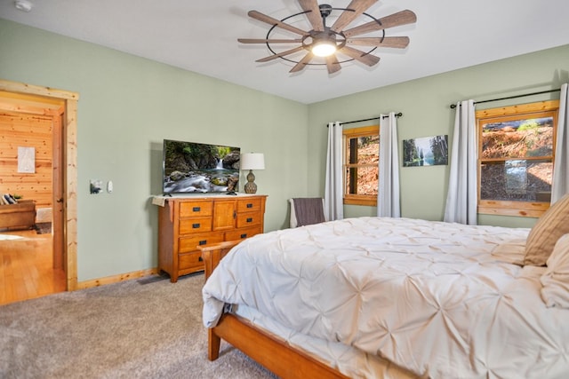 bedroom featuring carpet, a ceiling fan, and baseboards