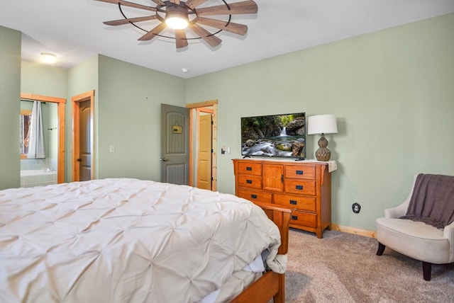 bedroom with light carpet, ensuite bath, ceiling fan, and baseboards