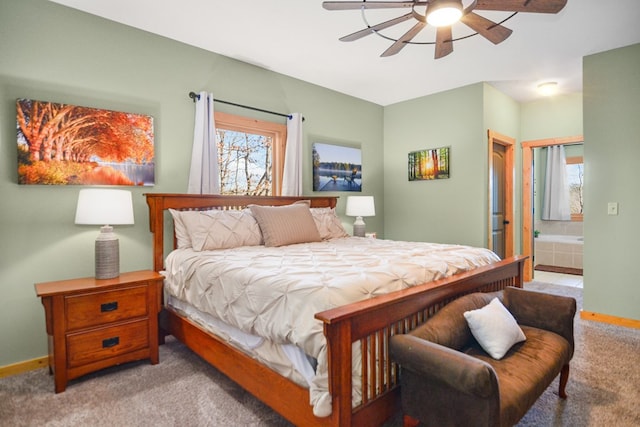 bedroom with light carpet, connected bathroom, baseboards, and a ceiling fan