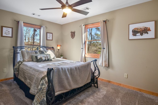 carpeted bedroom featuring baseboards and ceiling fan