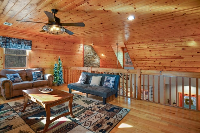 living room featuring wood ceiling, ceiling fan, wood finished floors, and wooden walls