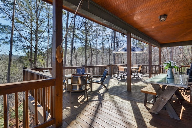 wooden deck featuring outdoor dining area