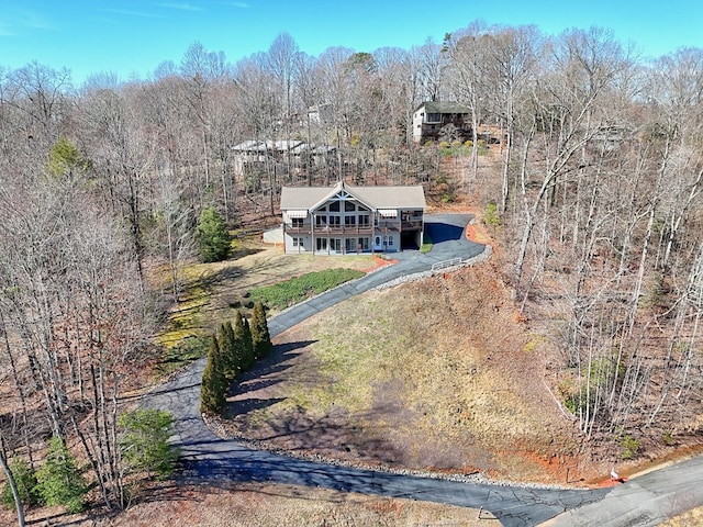 birds eye view of property with a forest view