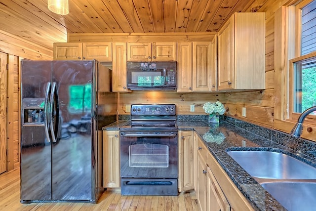 kitchen featuring sink, black appliances, wooden walls, light brown cabinetry, and wood ceiling