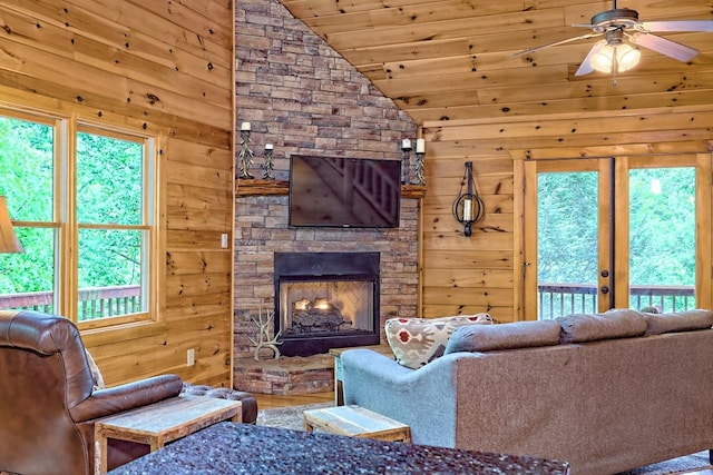 living room with wood walls, lofted ceiling, and wood ceiling