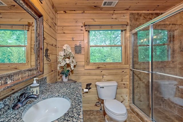 bathroom with toilet, wood walls, an enclosed shower, and sink