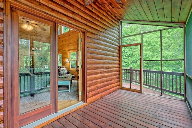 unfurnished sunroom with ceiling fan, wooden ceiling, and vaulted ceiling