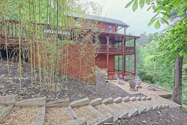 view of yard with an outdoor fire pit and a wooden deck