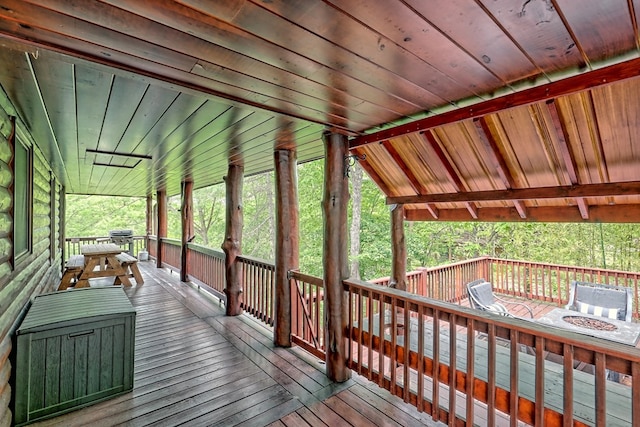 wooden terrace featuring area for grilling and covered porch