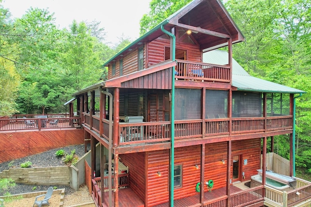 rear view of house featuring a sunroom