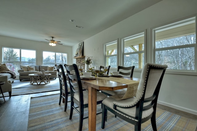 dining space with hardwood / wood-style flooring and ceiling fan