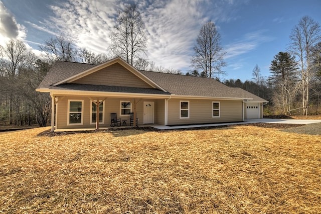 ranch-style home with a garage and a porch