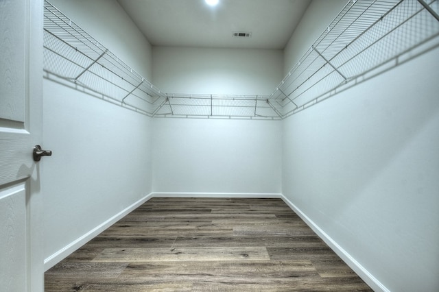 spacious closet with hardwood / wood-style floors