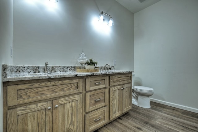 bathroom featuring hardwood / wood-style flooring, vanity, and toilet