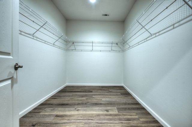 walk in closet with hardwood / wood-style floors