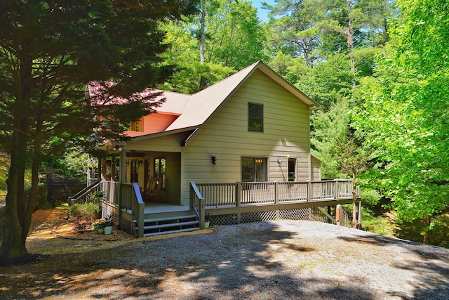 view of front of house featuring a deck and gravel driveway