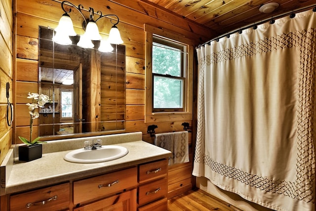 bathroom featuring wood walls, wood ceiling, vanity, curtained shower, and wood finished floors