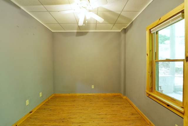 spare room featuring wood finished floors, ceiling fan, and baseboards