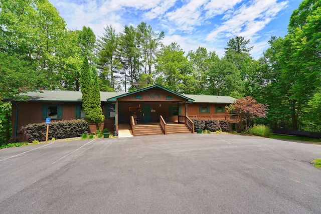 rustic home with covered porch and uncovered parking