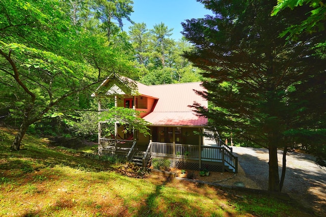 view of front of house with a porch and metal roof