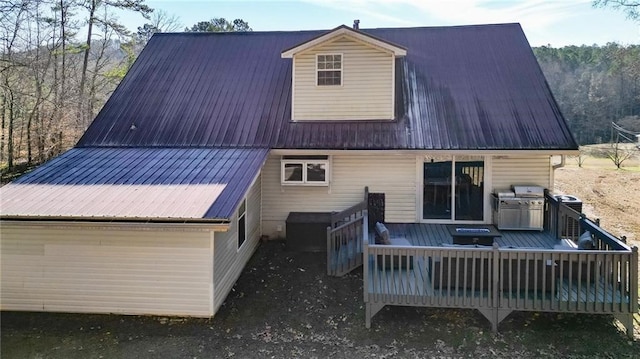 back of property featuring a wooden deck