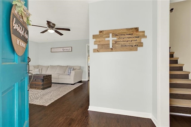 living room with ceiling fan and dark hardwood / wood-style flooring