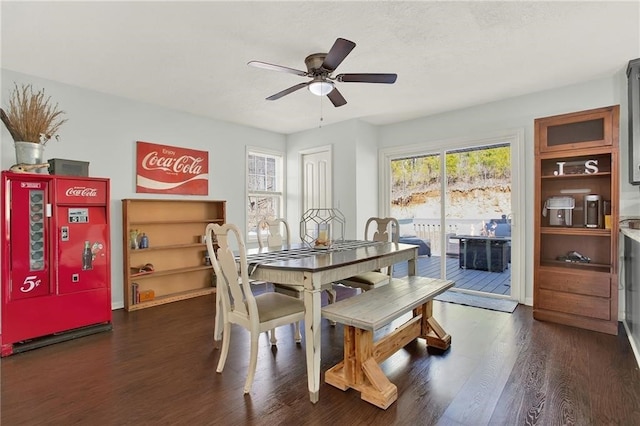 dining space featuring dark wood-type flooring and ceiling fan