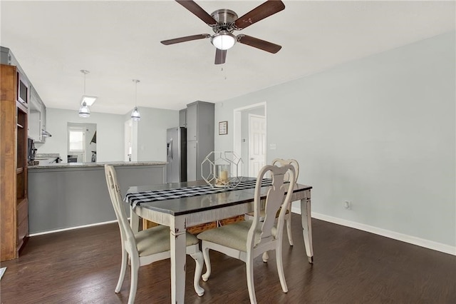 dining area featuring dark wood-type flooring and ceiling fan