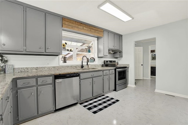 kitchen with appliances with stainless steel finishes, sink, and gray cabinetry