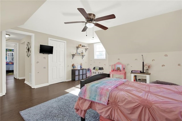 bedroom featuring ceiling fan, dark hardwood / wood-style floors, and vaulted ceiling