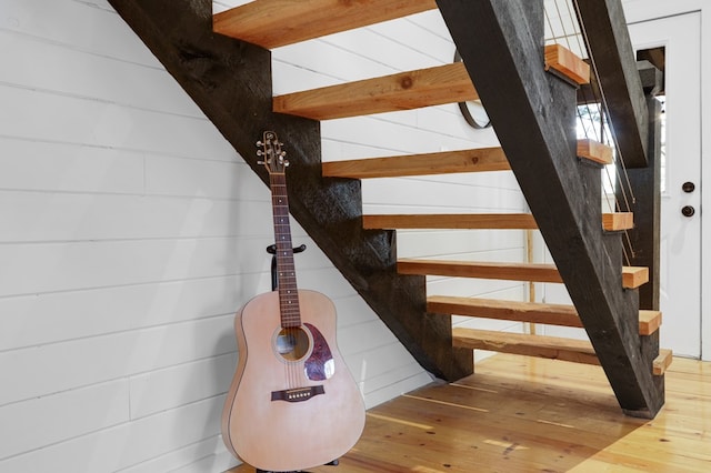 stairs featuring hardwood / wood-style flooring