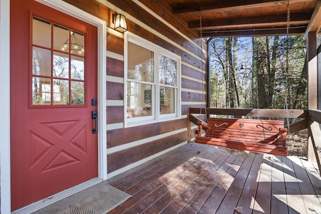 view of exterior entry with a deck