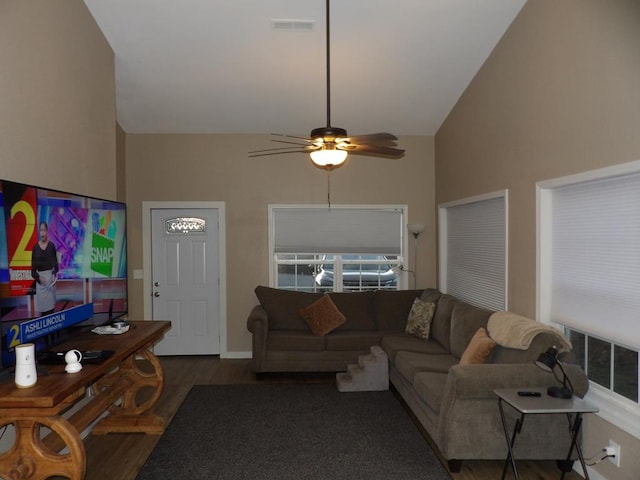 living area with visible vents, high vaulted ceiling, dark wood-type flooring, and a ceiling fan