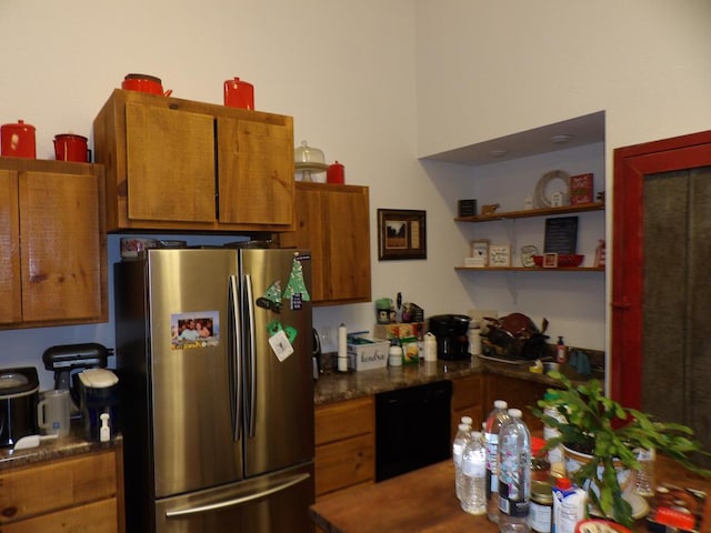 kitchen with brown cabinets, dishwasher, and freestanding refrigerator