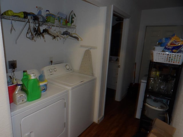 laundry area with laundry area, dark wood-style flooring, and washing machine and dryer